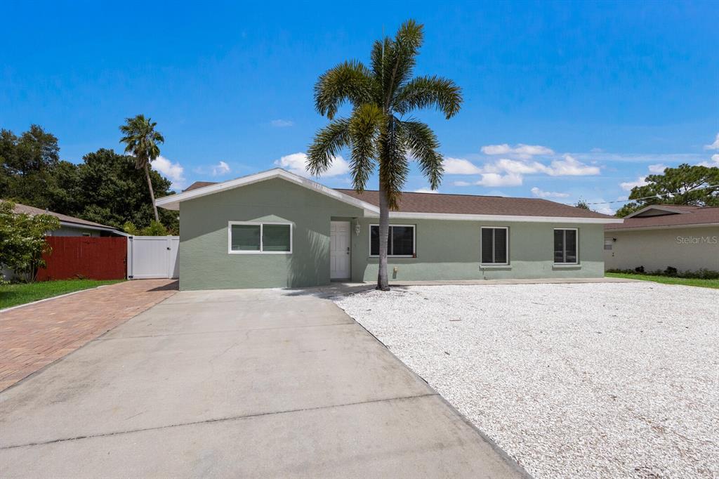 a palm tree in front of a house