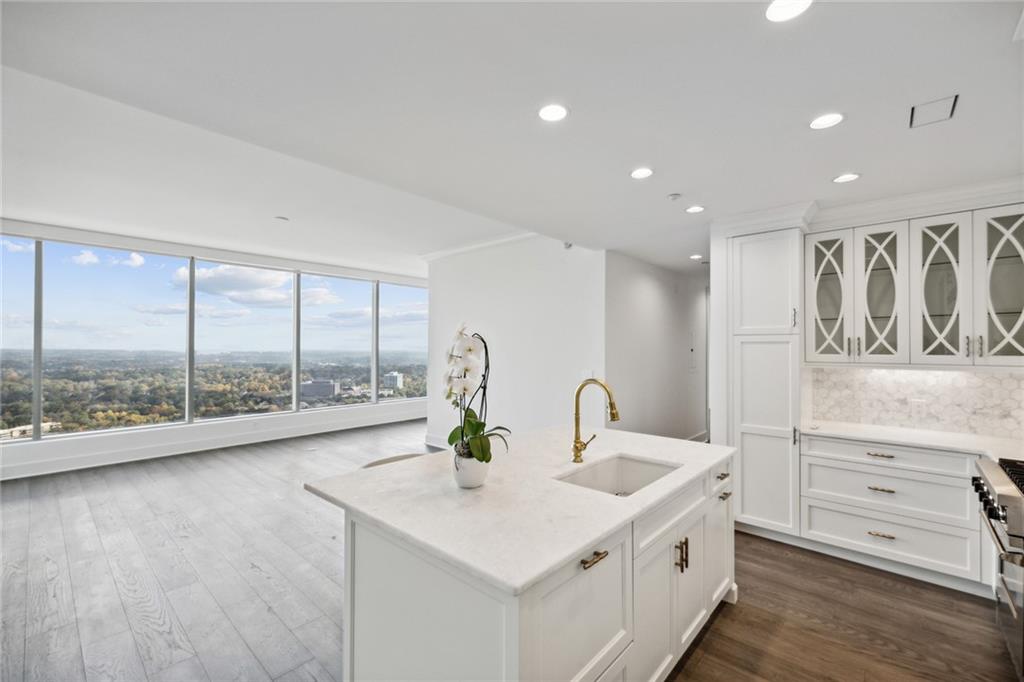 a kitchen with stainless steel appliances a sink and cabinets