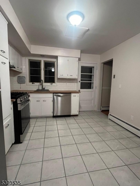 a kitchen with stainless steel appliances a stove a sink and a refrigerator