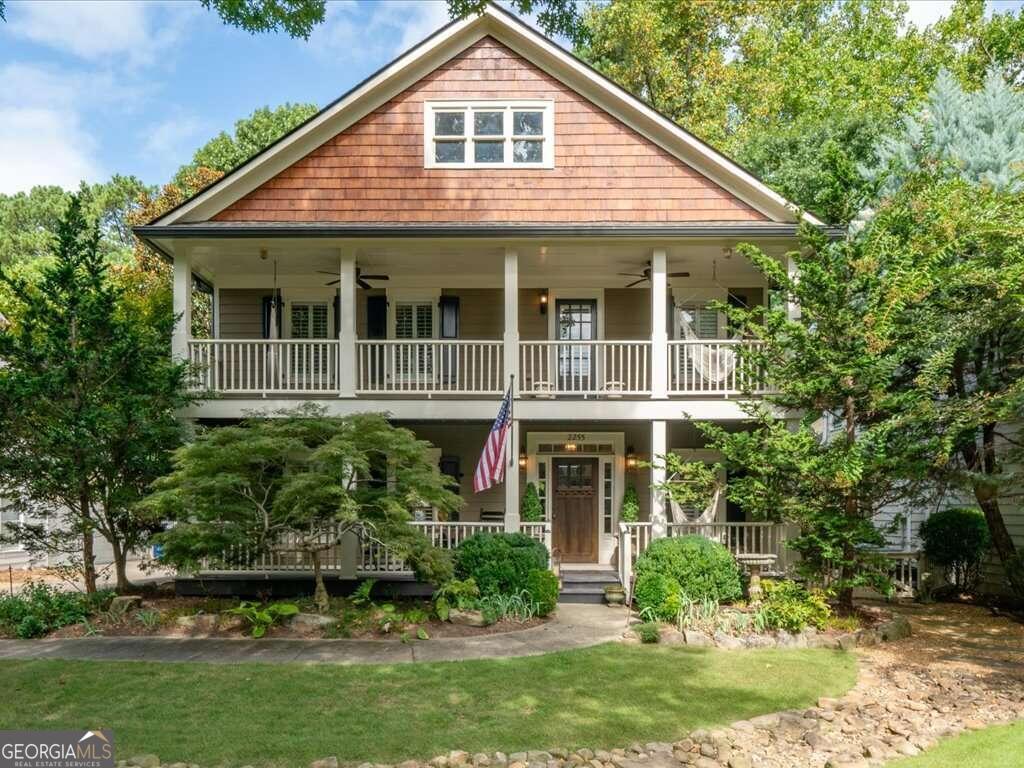 a front view of a house with a yard and potted plants