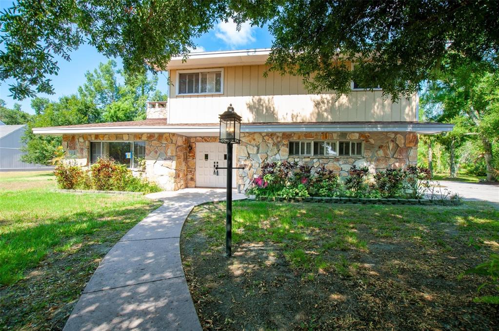 a front view of a house with garden