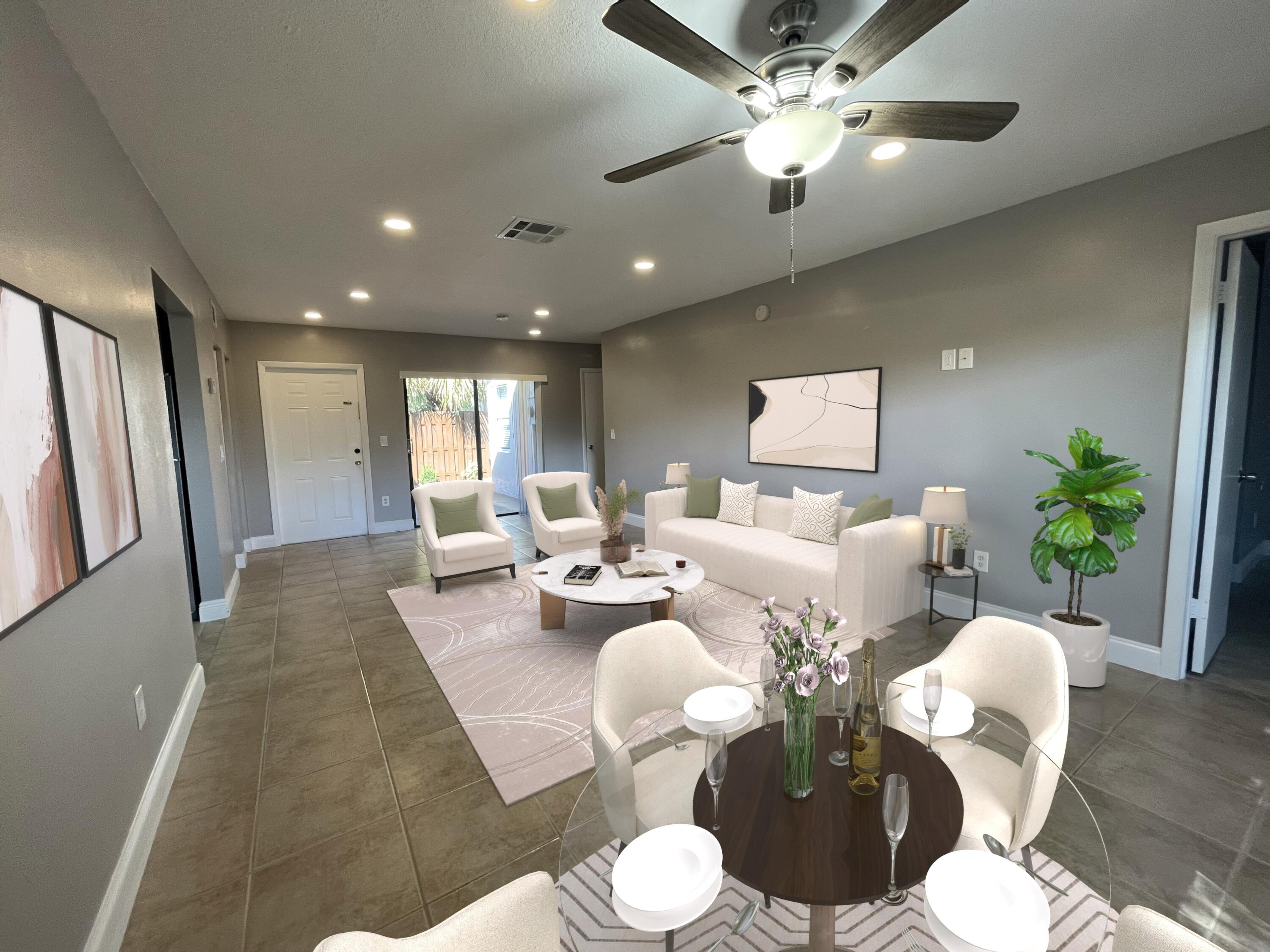 a living room with furniture a chandelier and a dining room