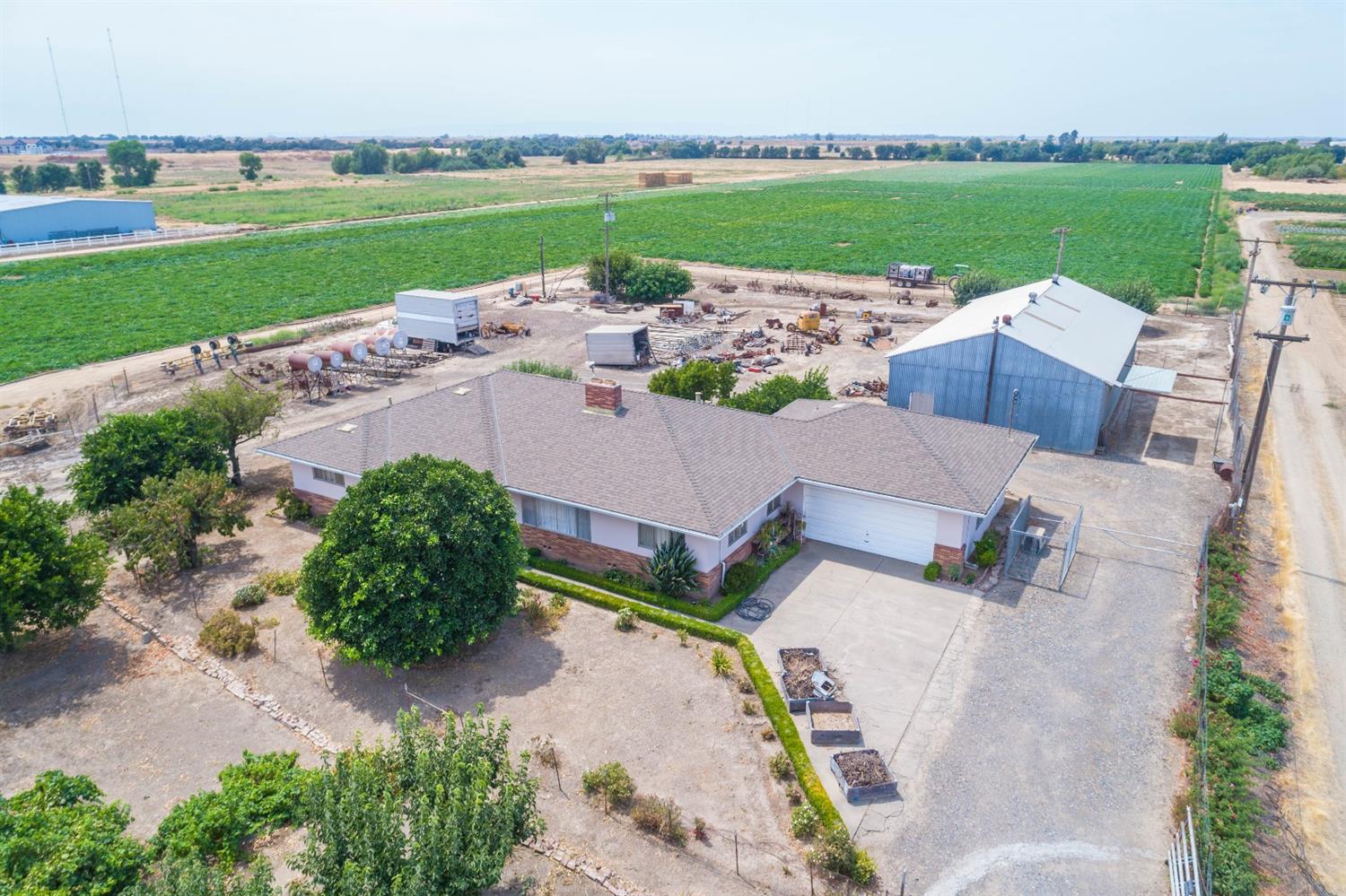 an aerial view of a house with outdoor space and seating