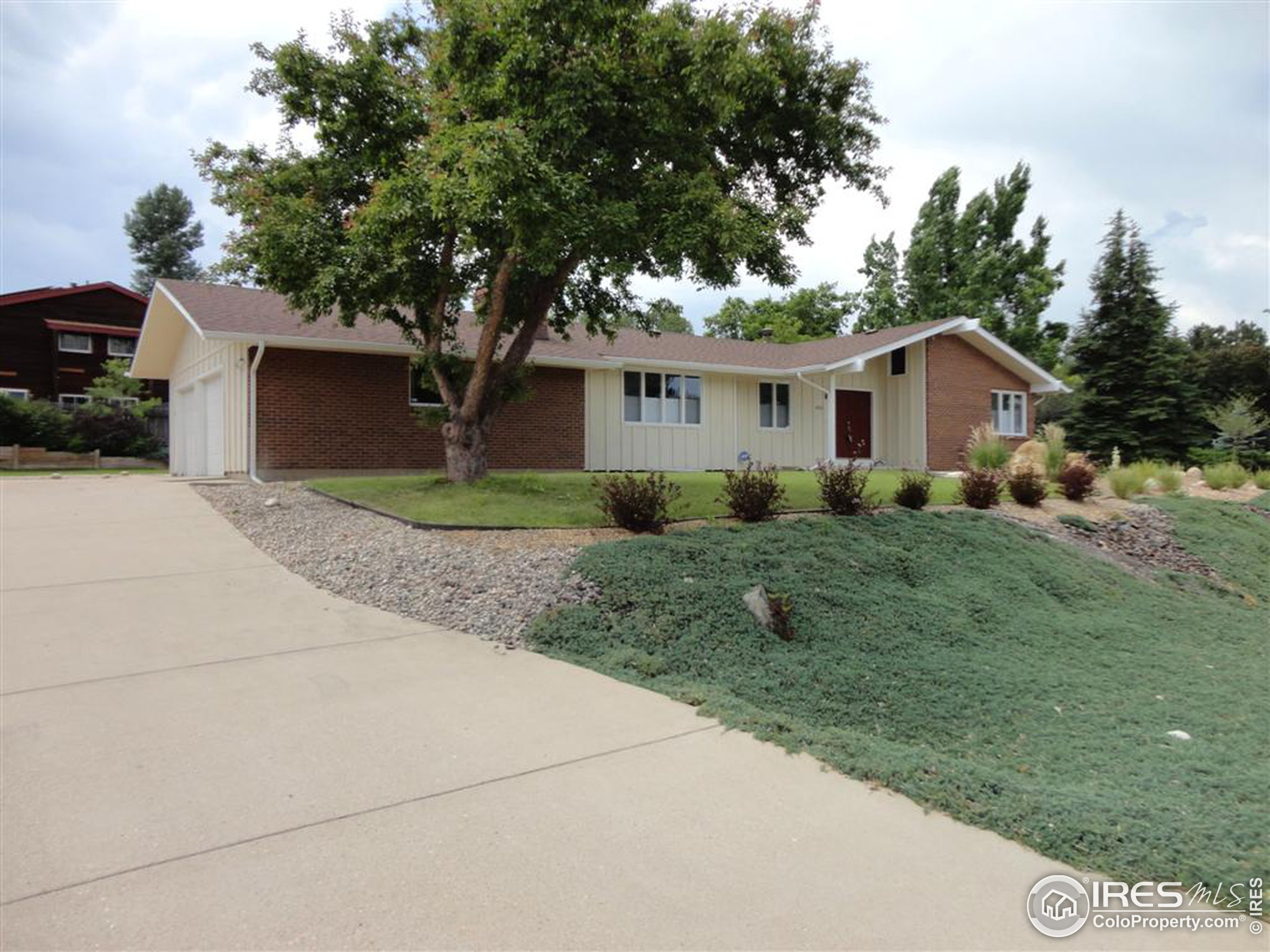 a front view of house with yard and trees