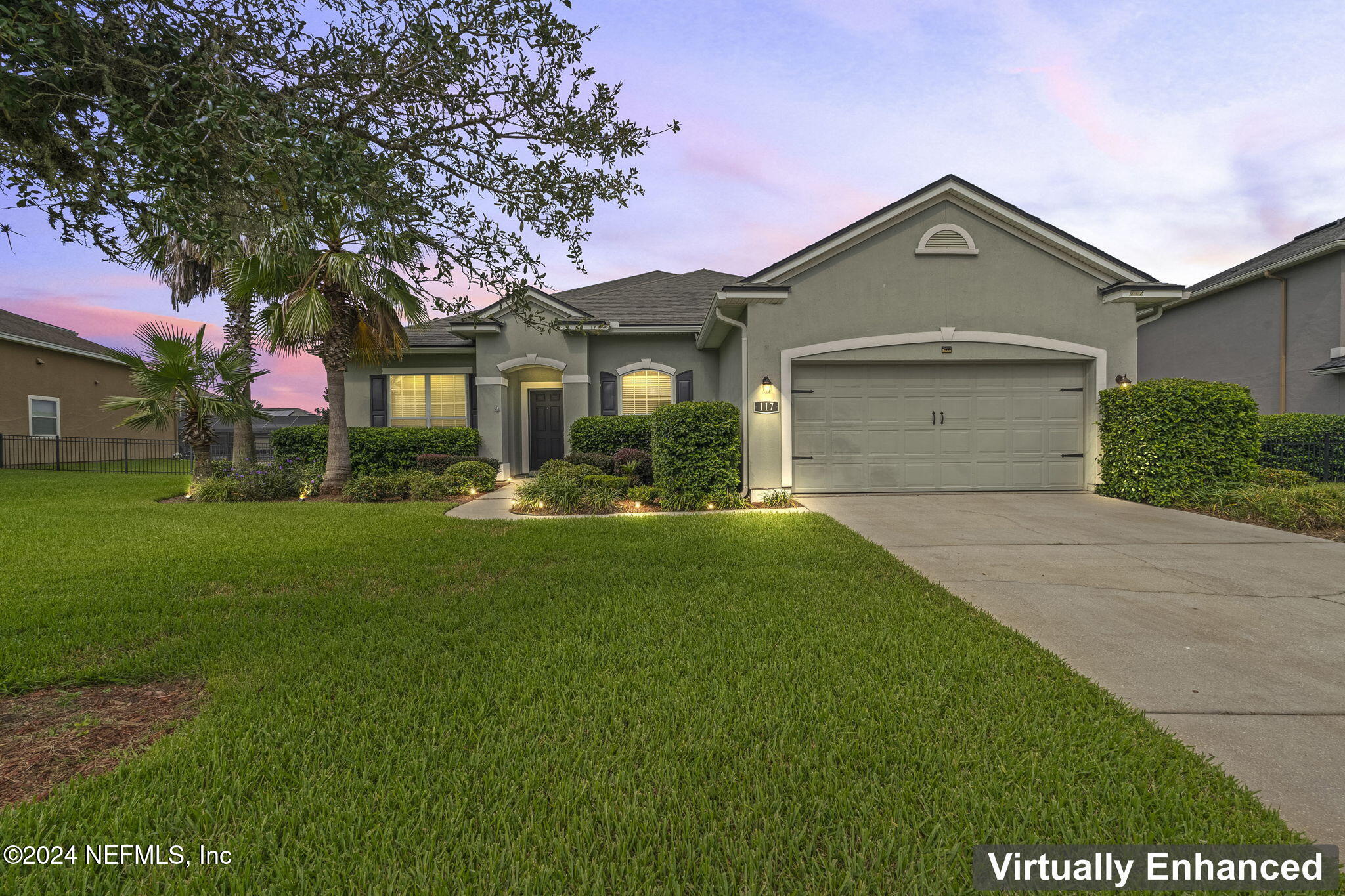 a front view of a house with a yard and garage