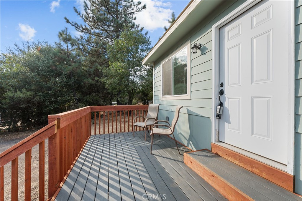 a view of deck with table and chairs and wooden floor