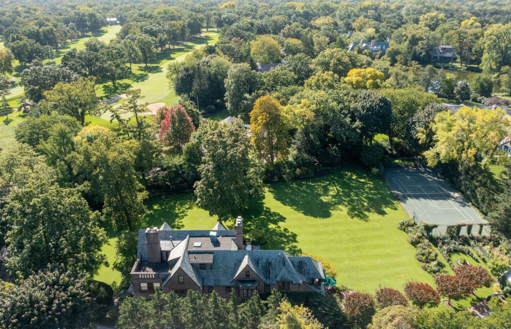 an aerial view of a house with yard swimming pool and outdoor seating