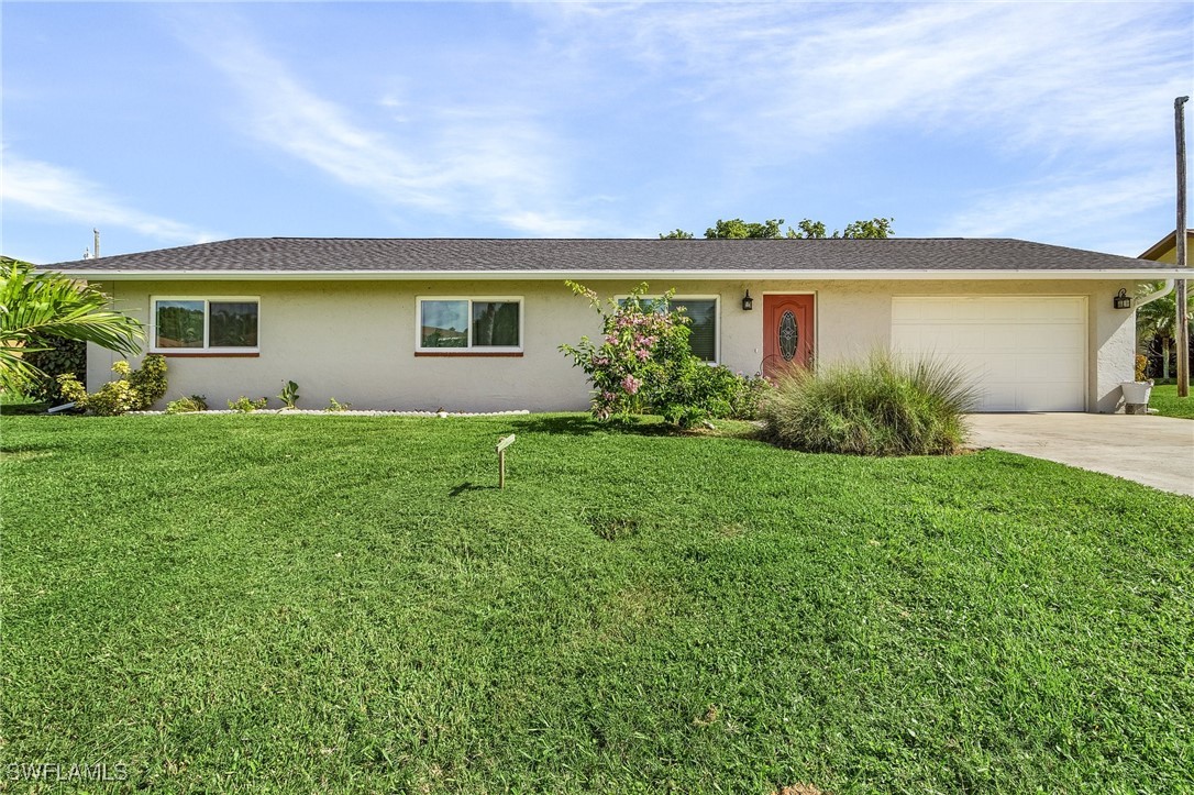 a front view of house with yard and green space