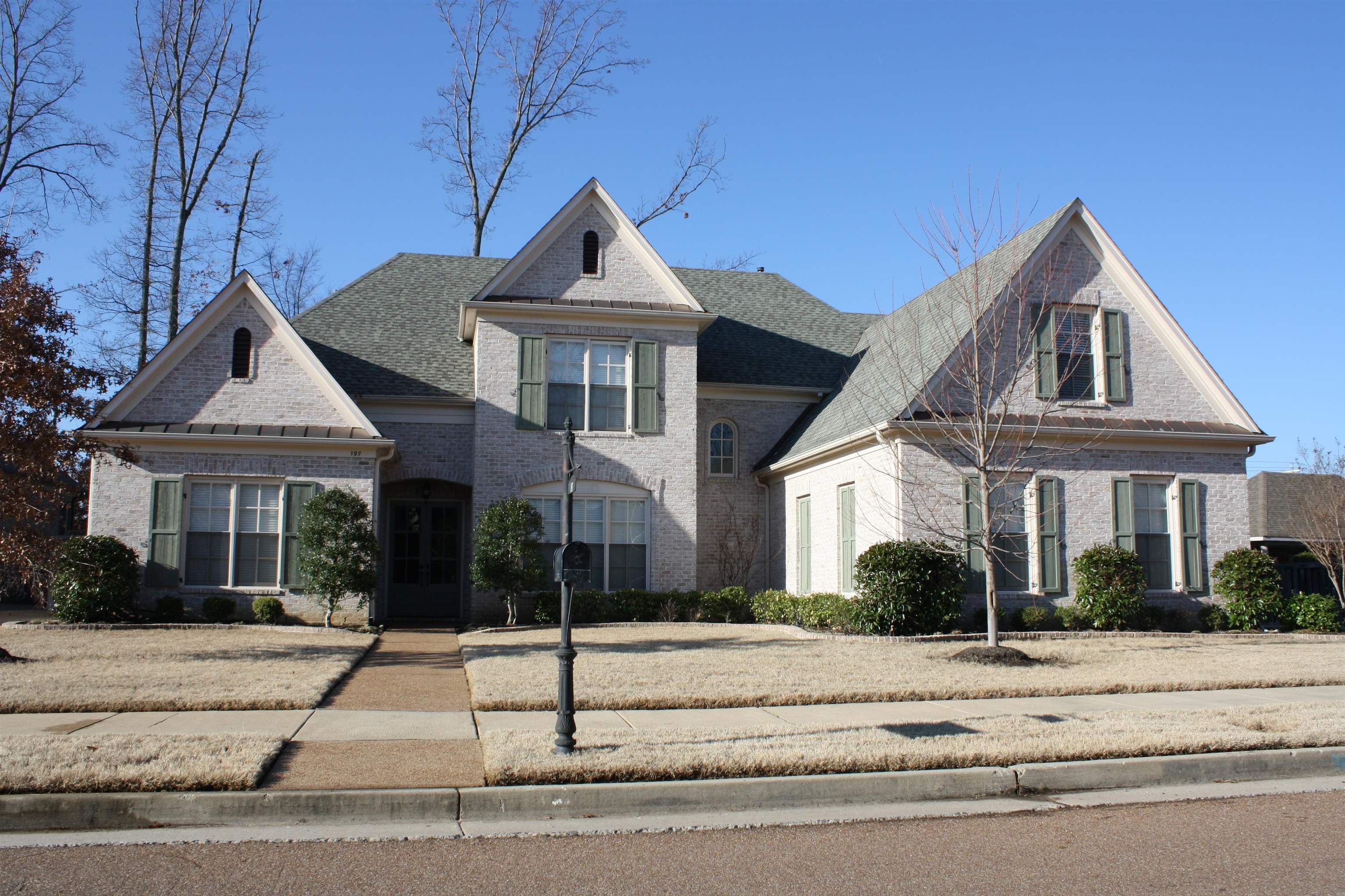 a front view of a house with a yard