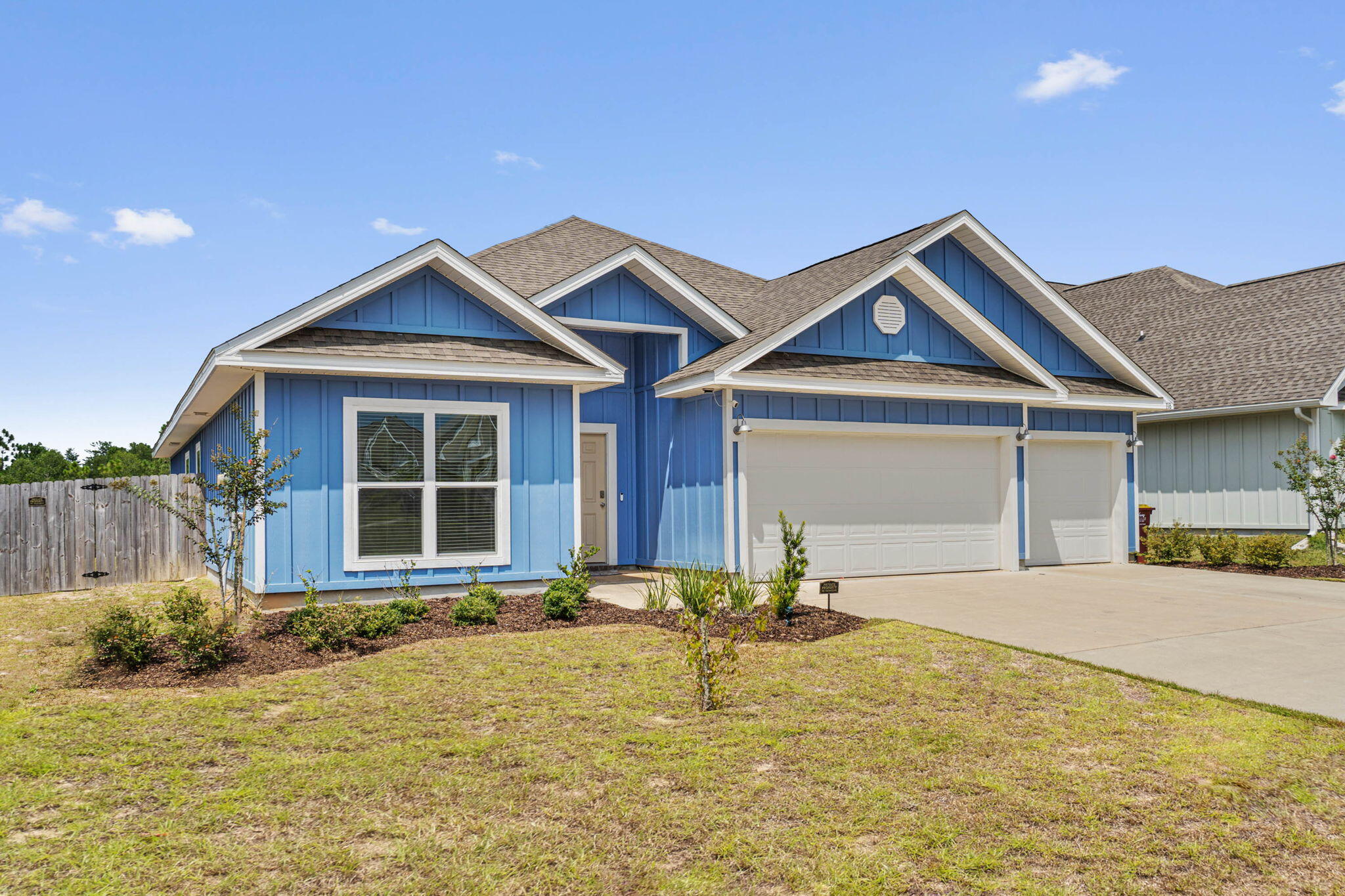 a front view of a house with a yard outdoor seating and garage