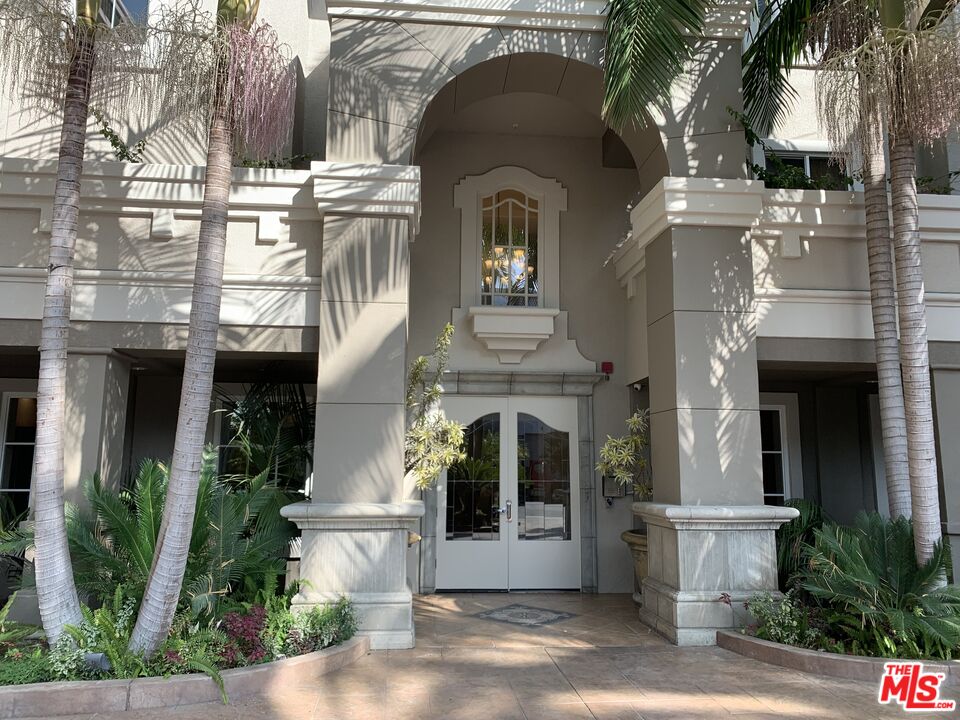 a front view of a house with plants