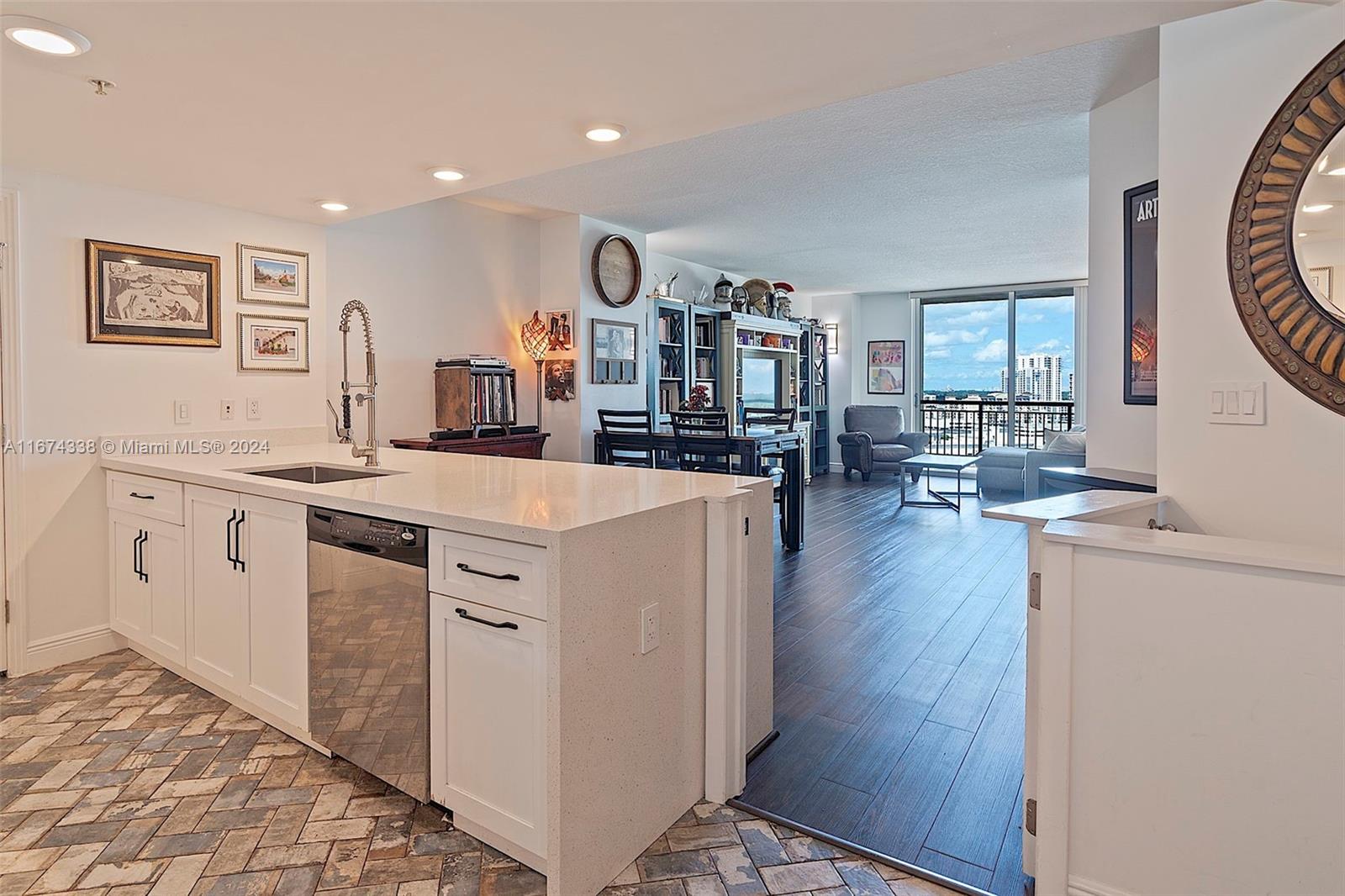 a view of a kitchen with furniture and wooden floor