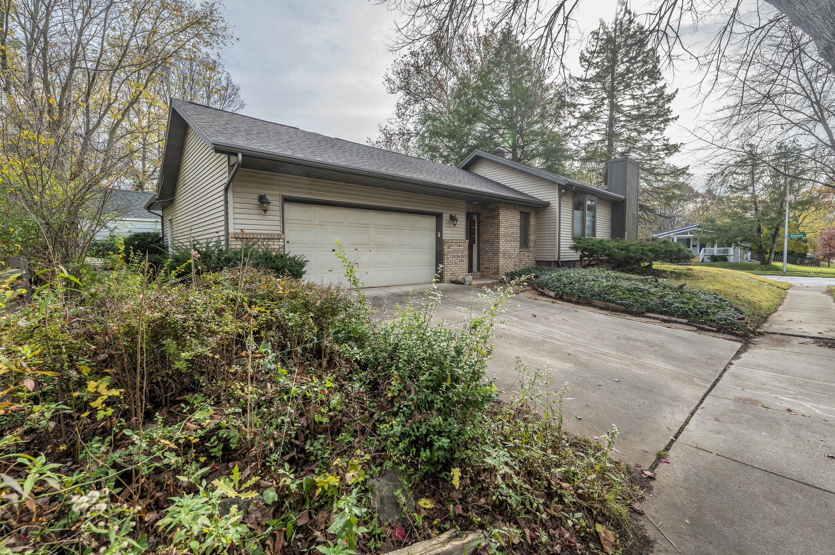 a front view of a house with a yard and trees