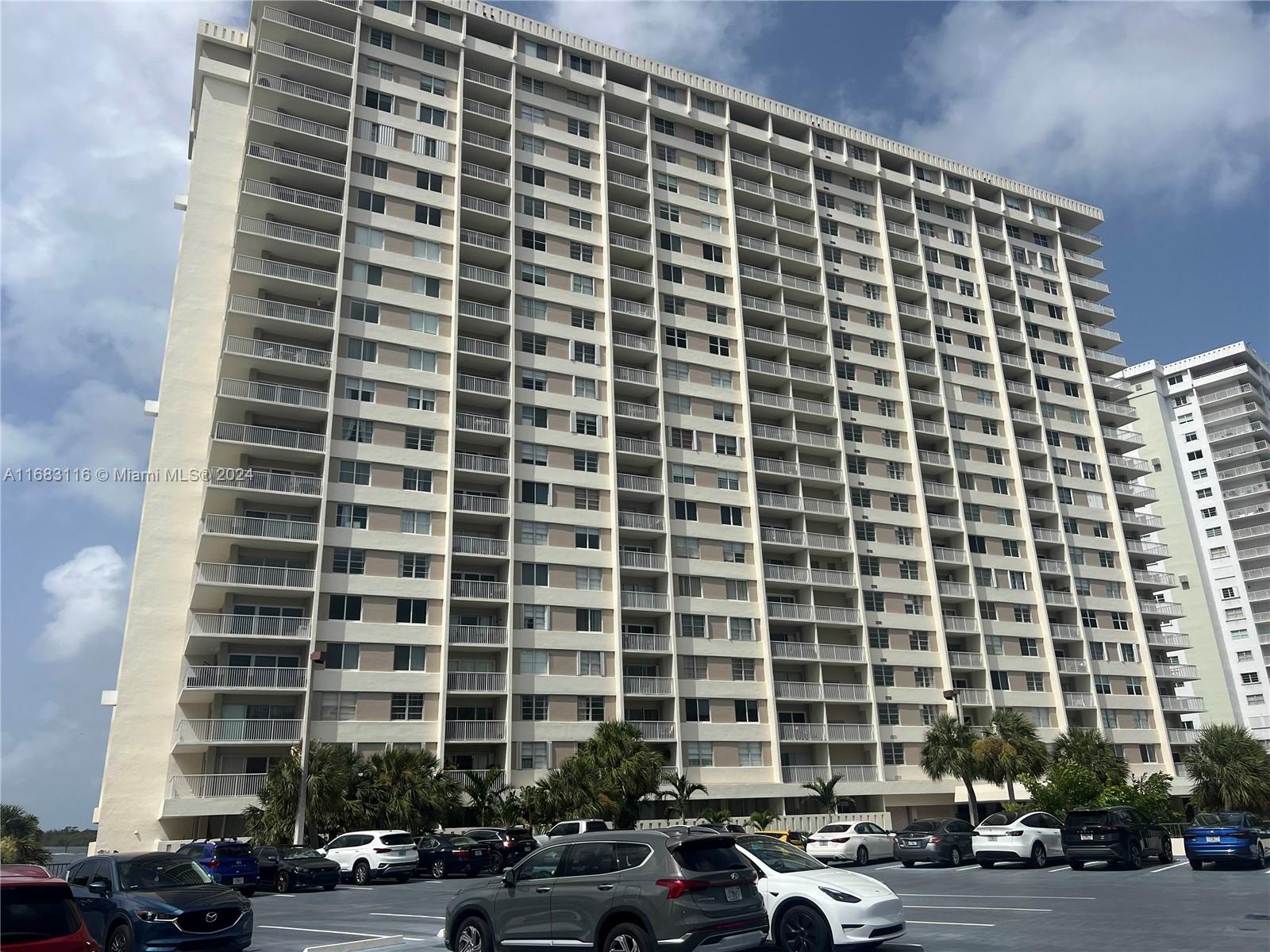 a front view of a building with car parked