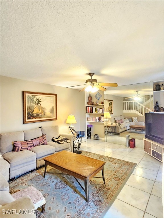 a living room with furniture a rug and a lamp