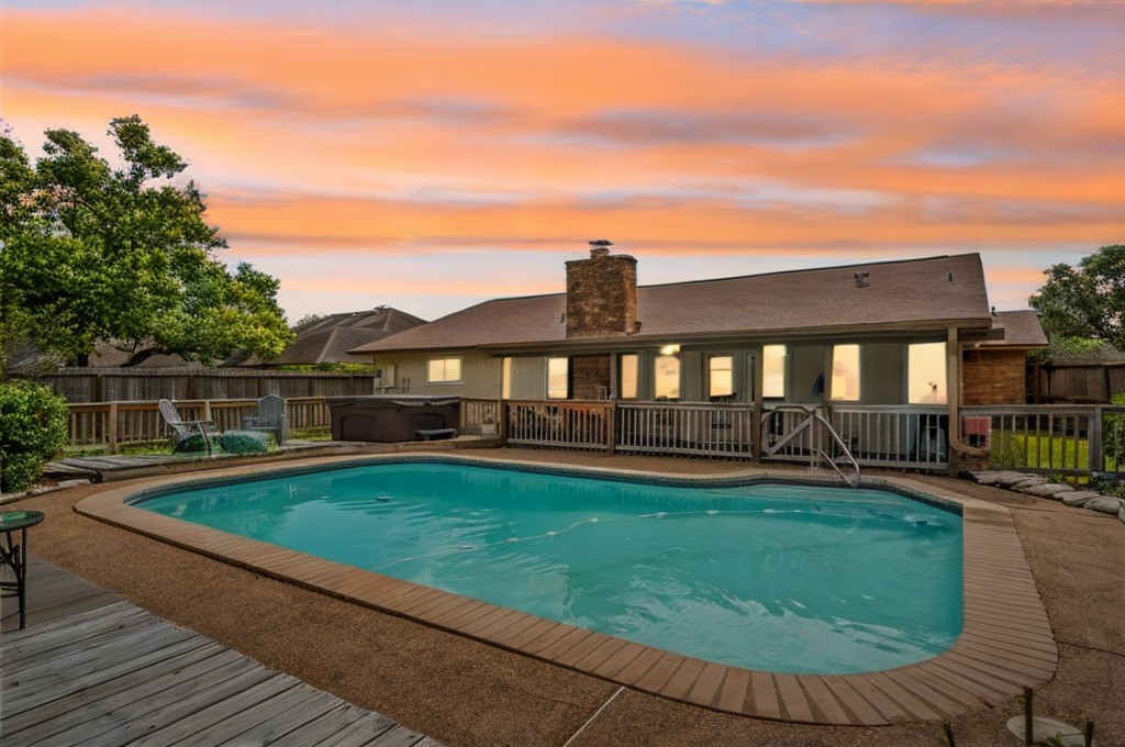 a view of a house with swimming pool and sitting area