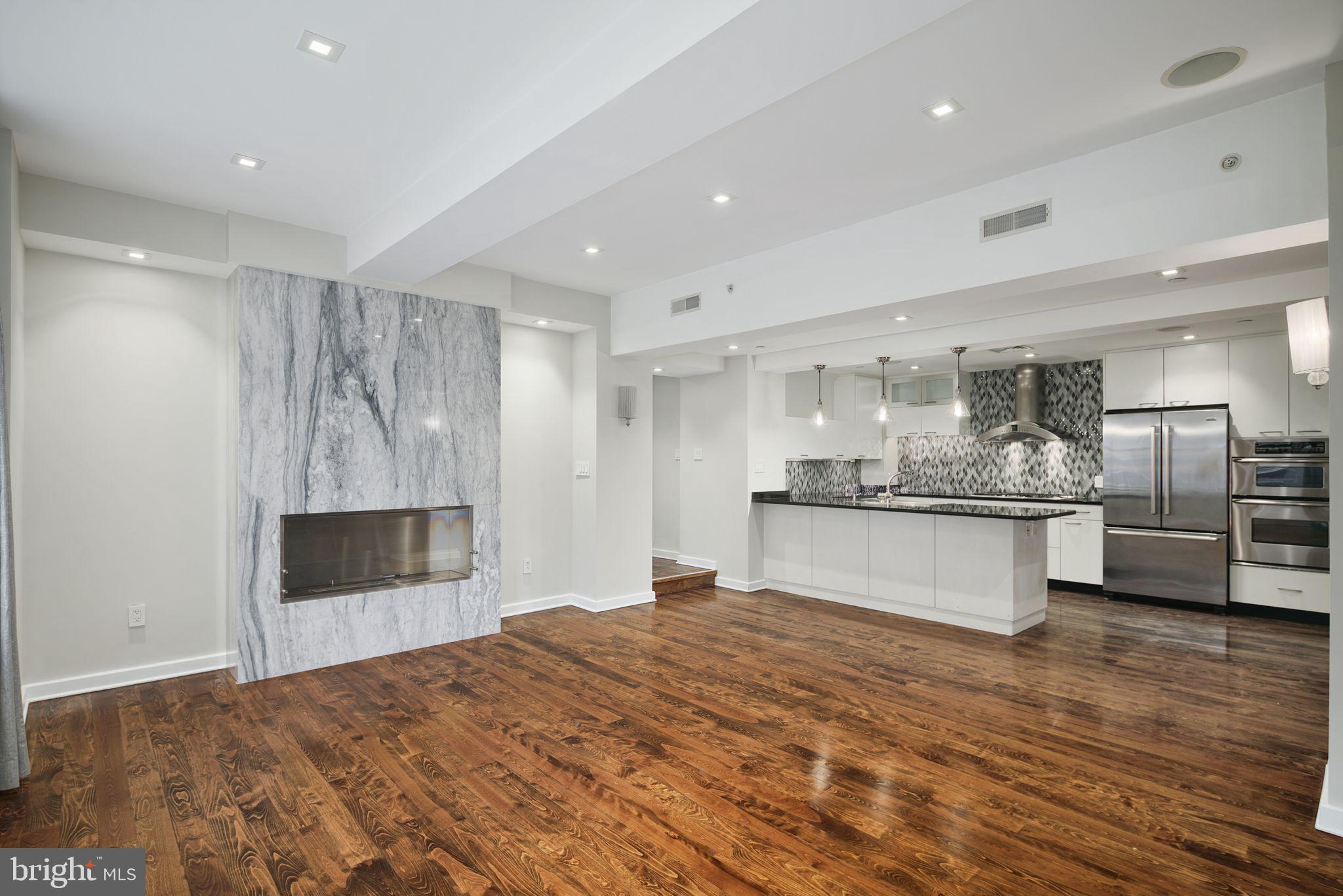 a large kitchen with kitchen island a sink stainless steel appliances and cabinets