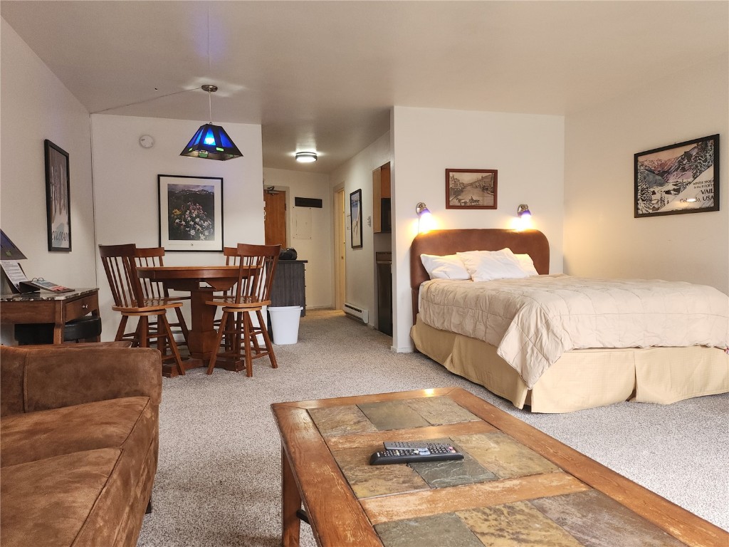 a bedroom with furniture and a wooden floor