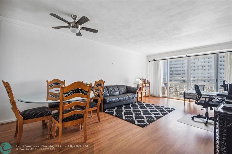 Open, bright living room with impact sliders (4 years old) and split AC (5 years old).