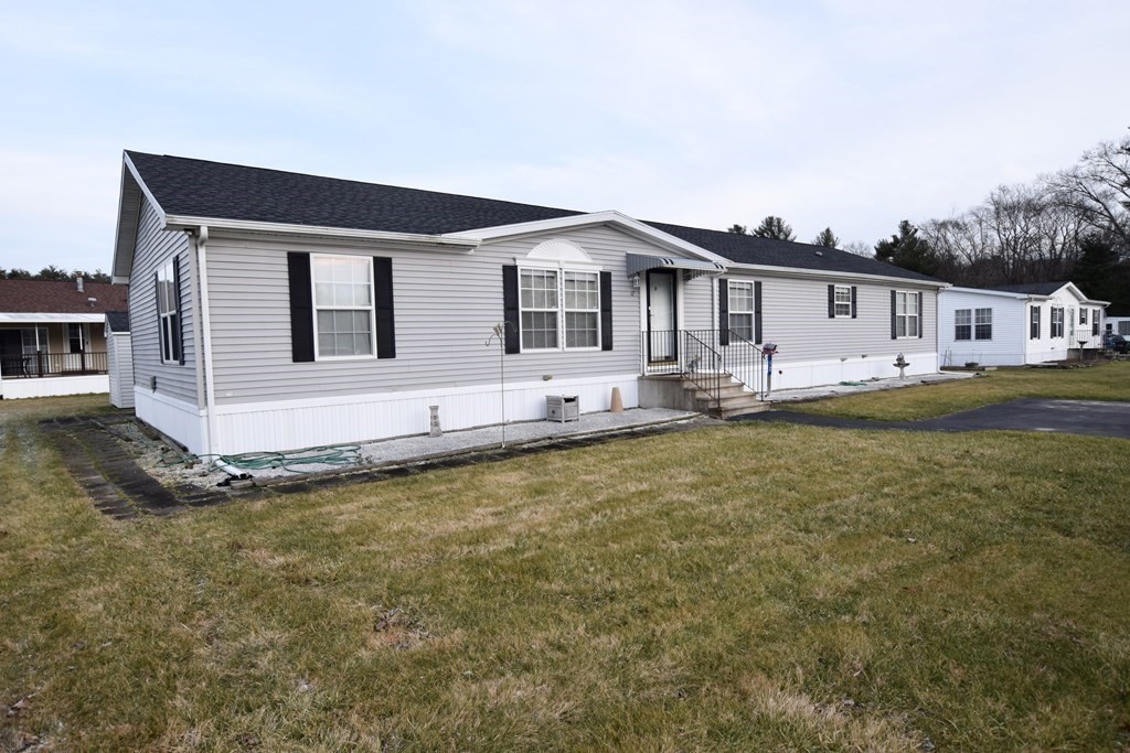 a front view of a house with a garden and yard