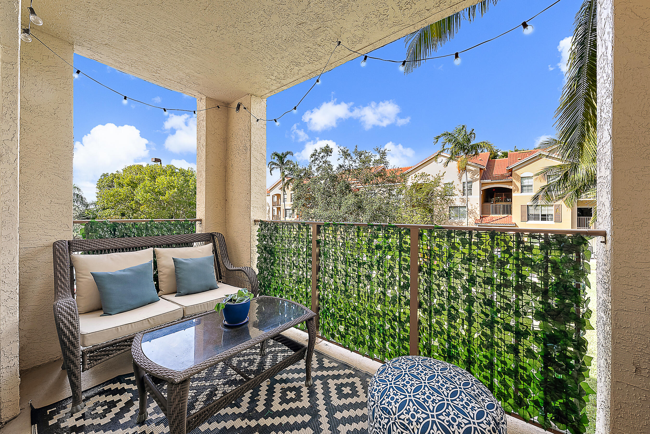 a balcony with table and chairs