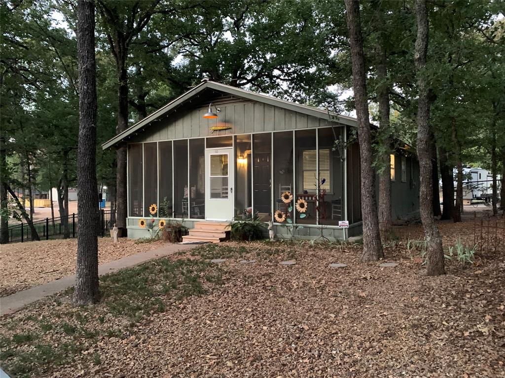 a view of a house with a yard and tree s