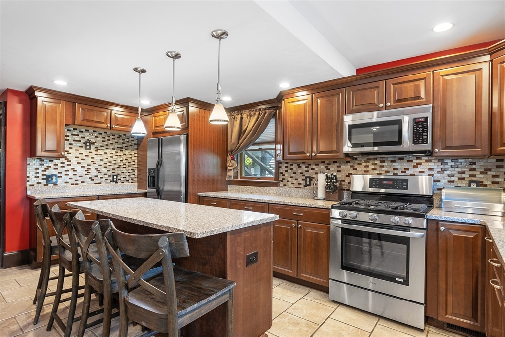 a kitchen with a stove a sink and a microwave