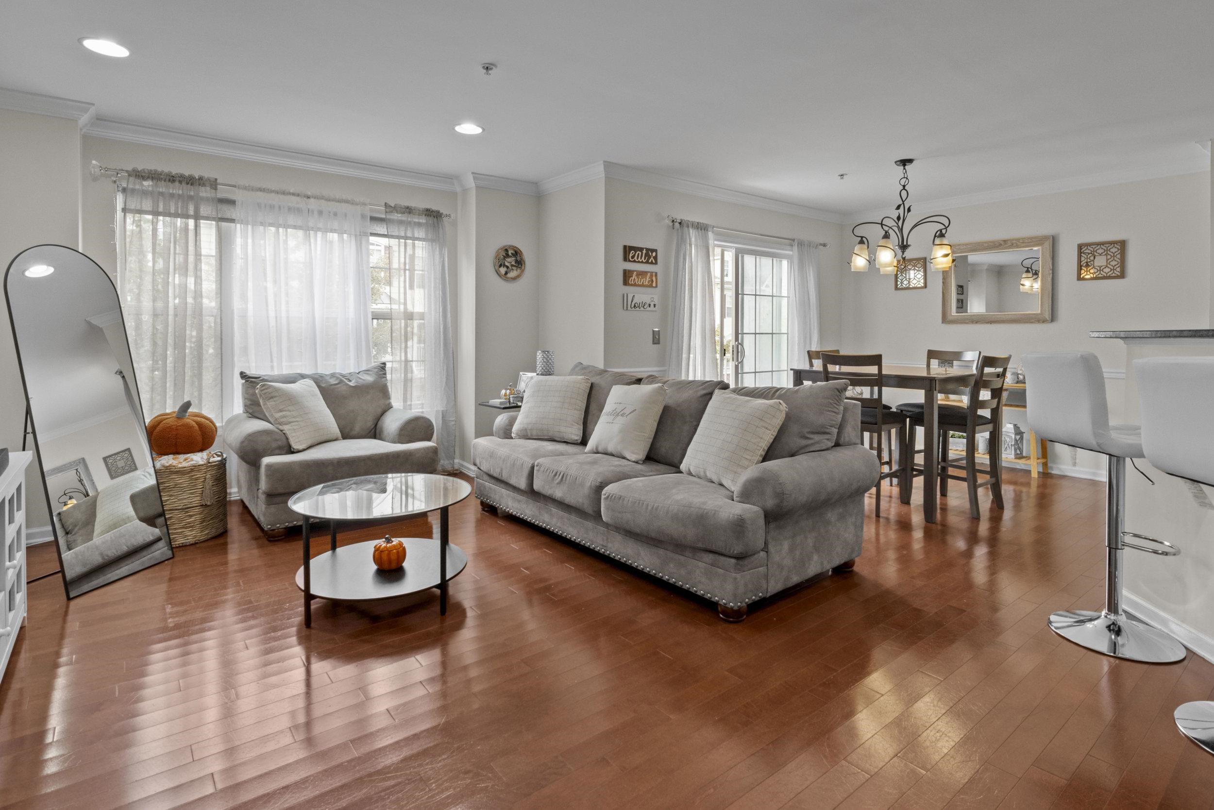 a living room with furniture and wooden floor