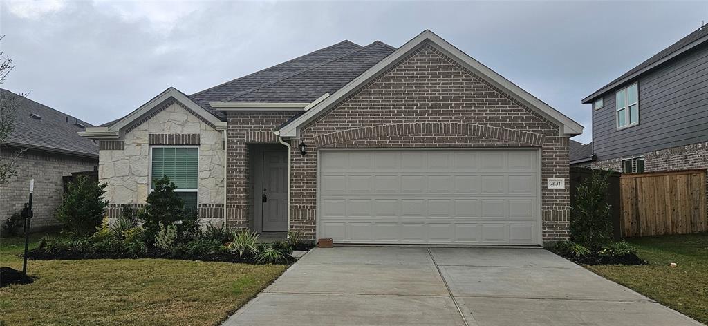 a front view of a house with yard and garage