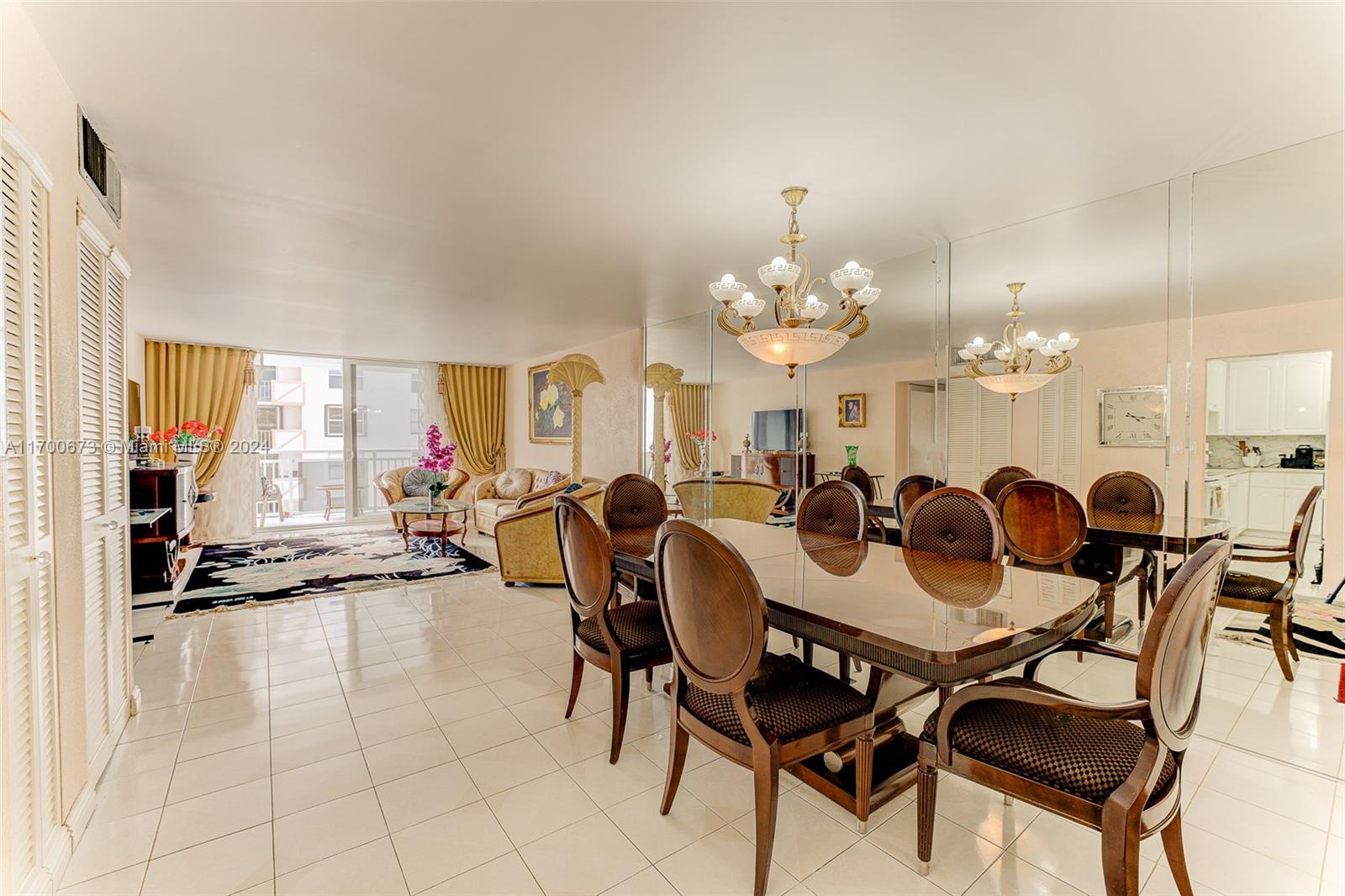 a view of a dining room with furniture and a chandelier