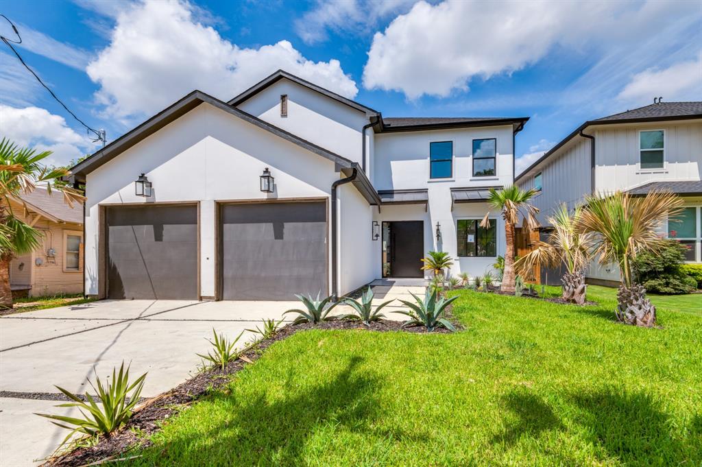 a front view of a house with a yard and garage