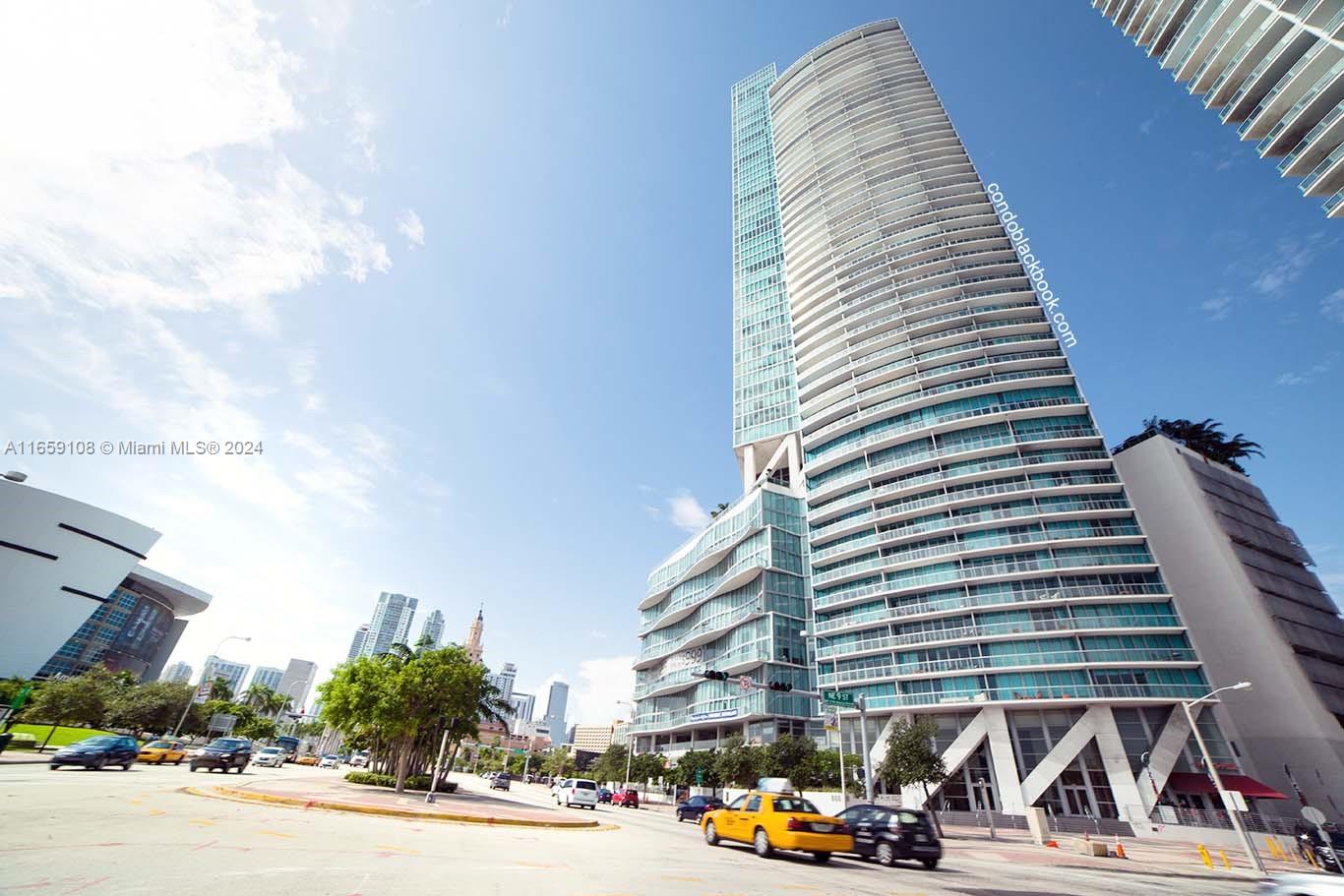 a view of a tall building next to a road