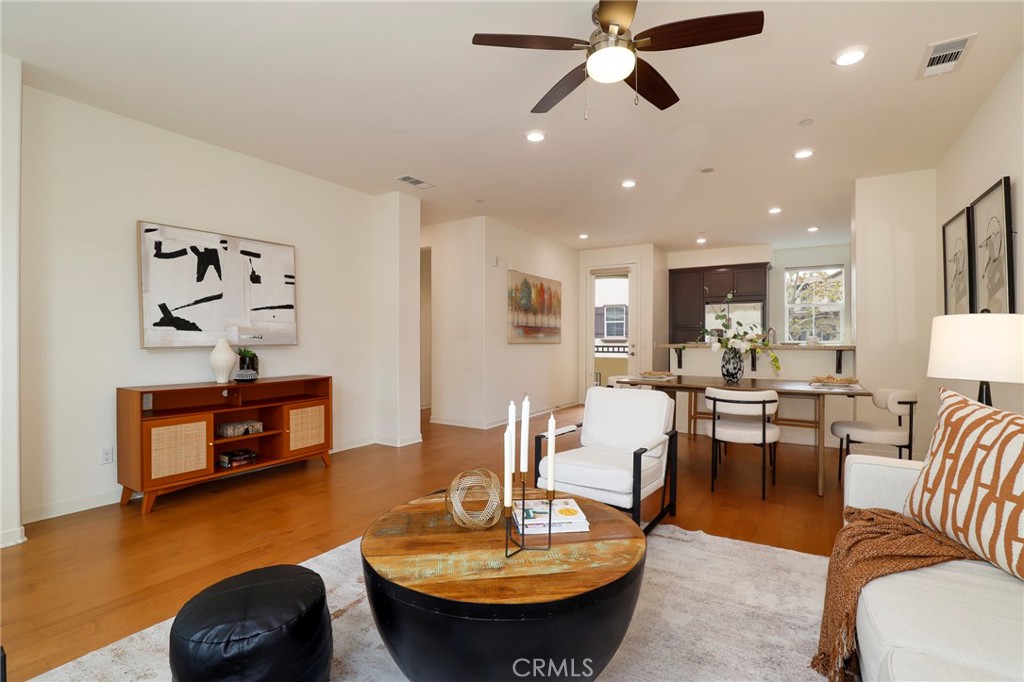 a living room with furniture and a wooden floor