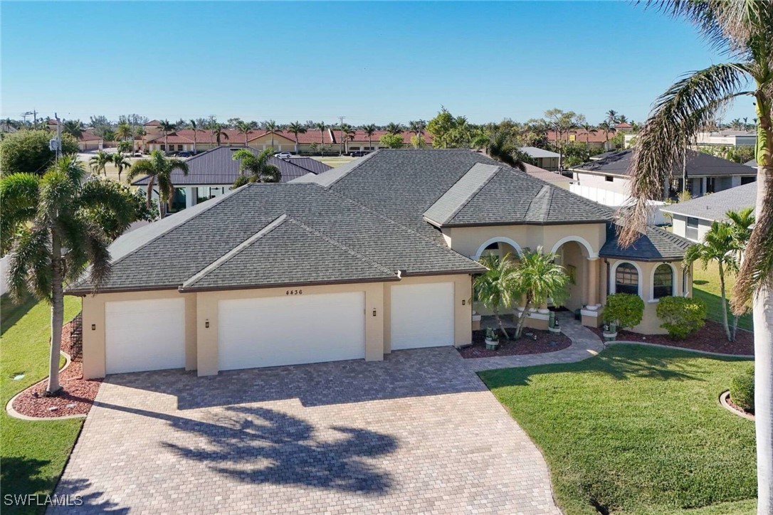 an aerial view of a house with a yard and potted plants