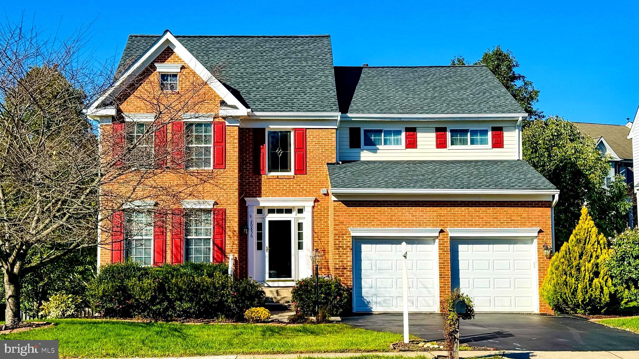 a front view of houses with yard