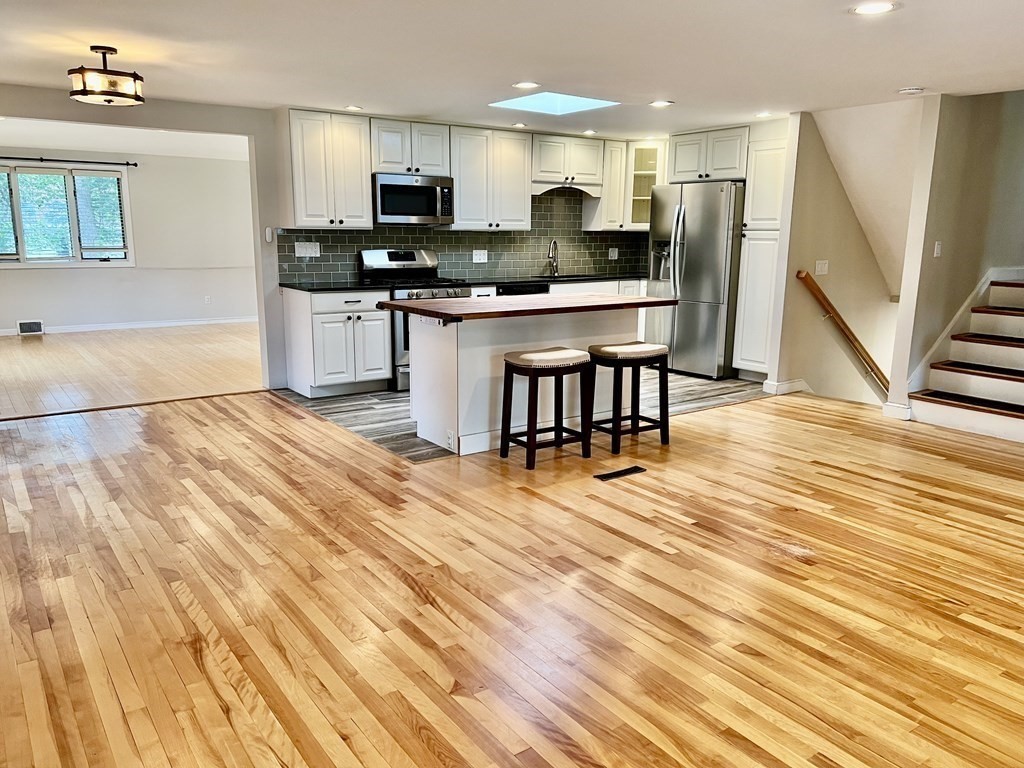 a kitchen with stainless steel appliances kitchen island granite countertop a sink and cabinets