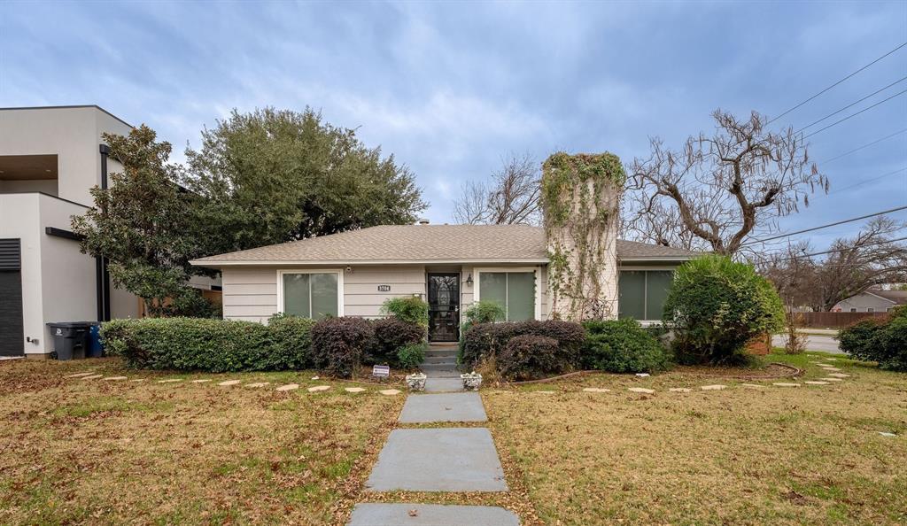 a front view of house with yard and trees around