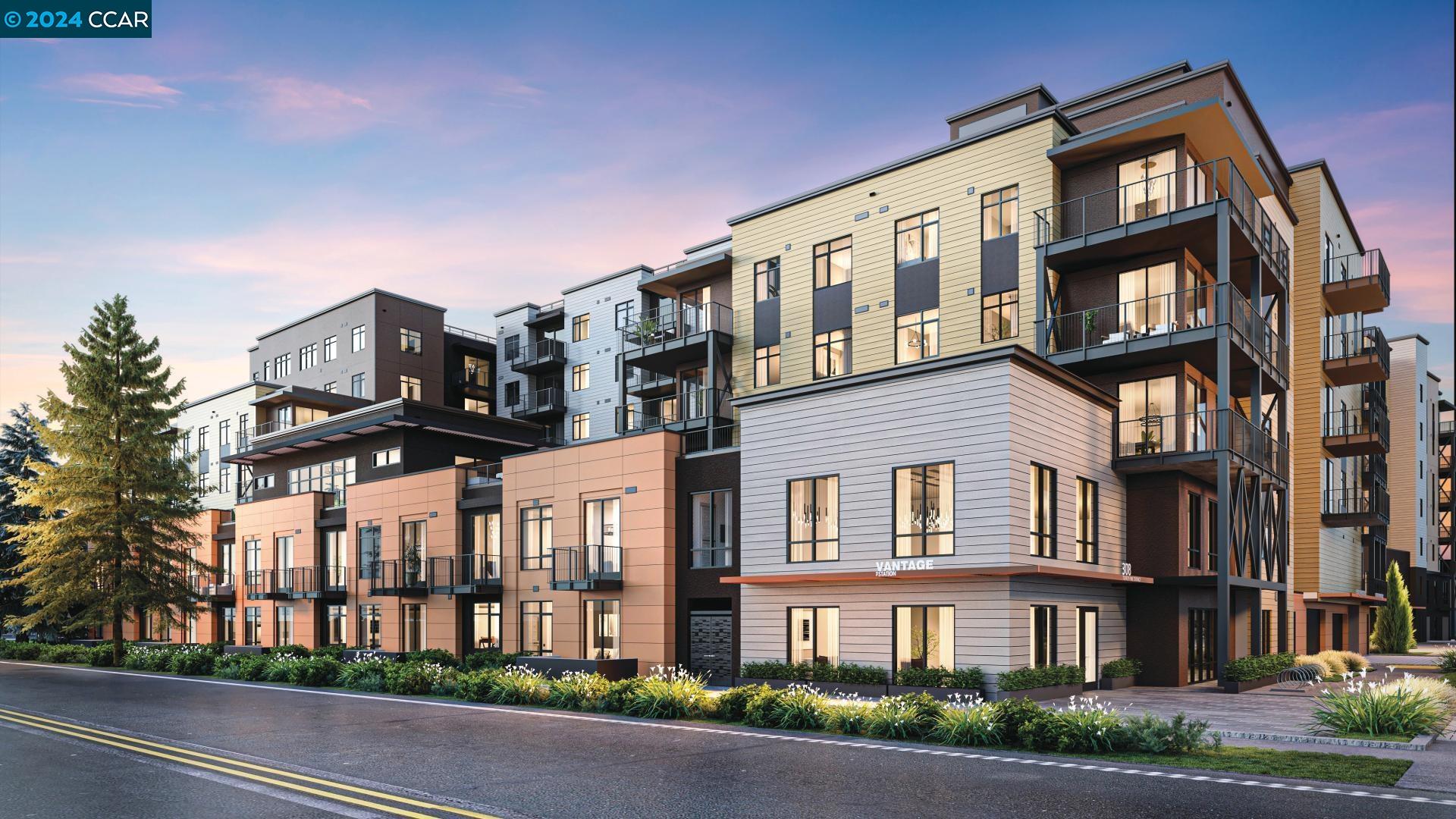 a front view of a residential apartment building with a yard