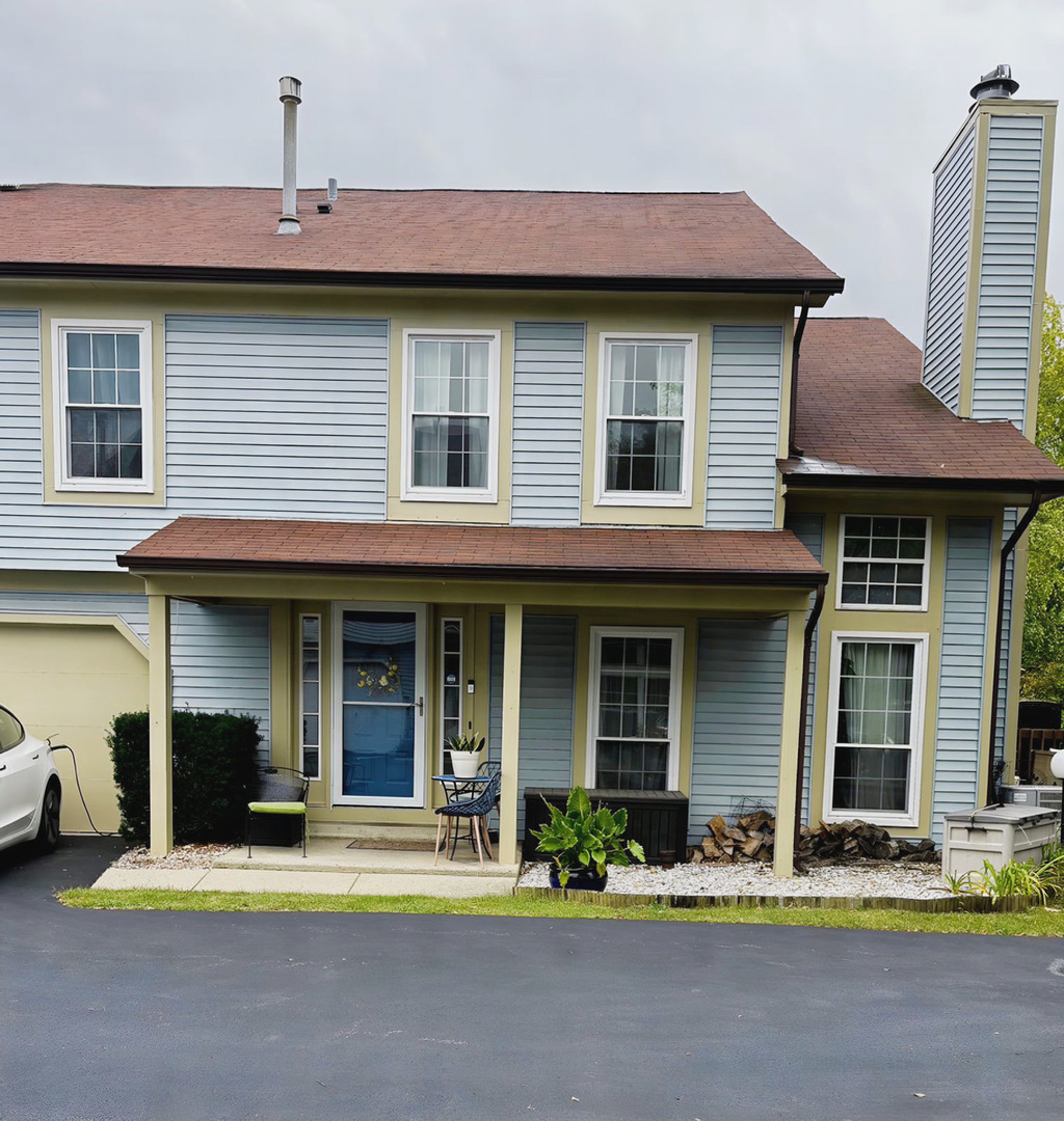 a front view of a house with yard outdoor seating and garage