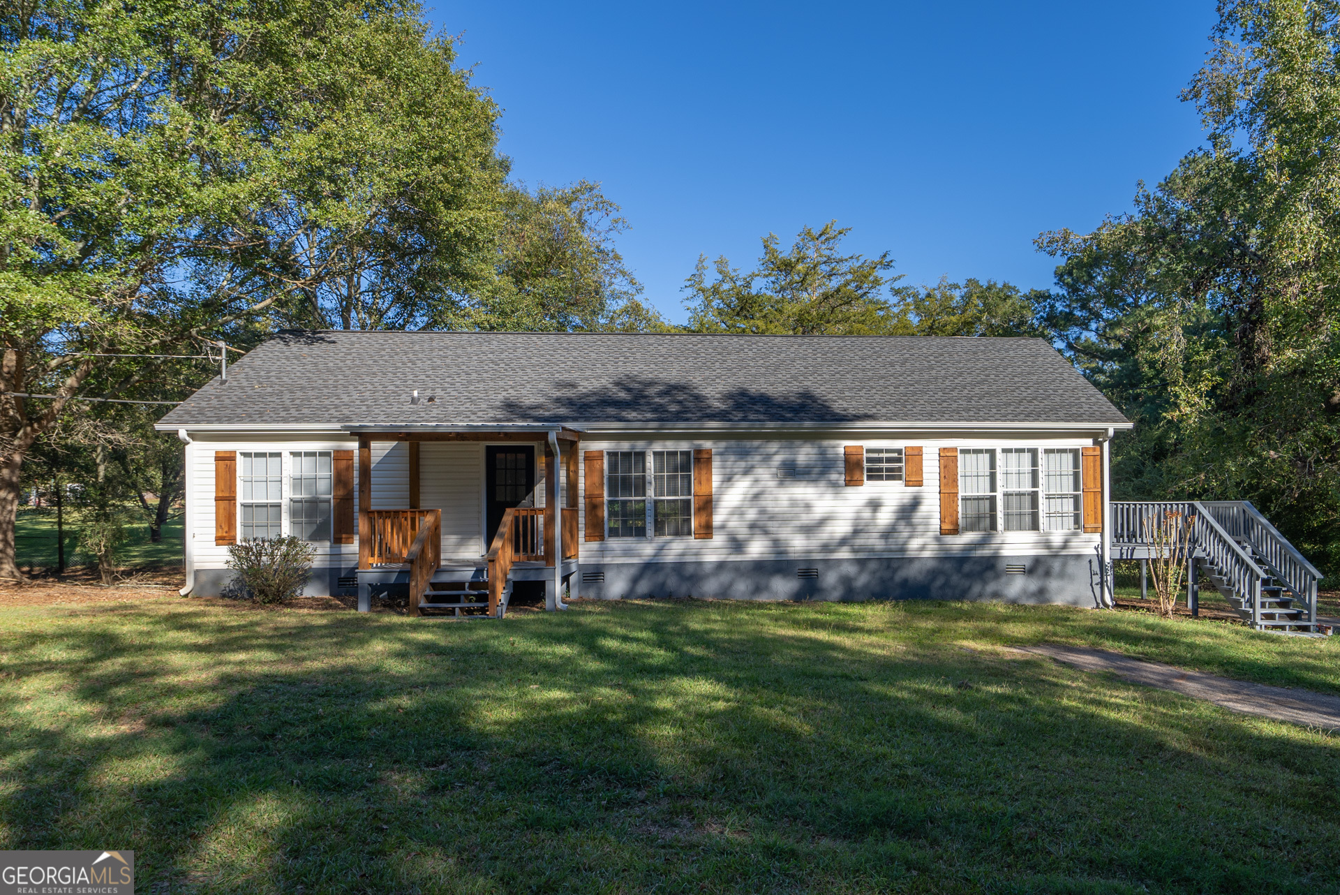 a view of a house with a yard porch and sitting area