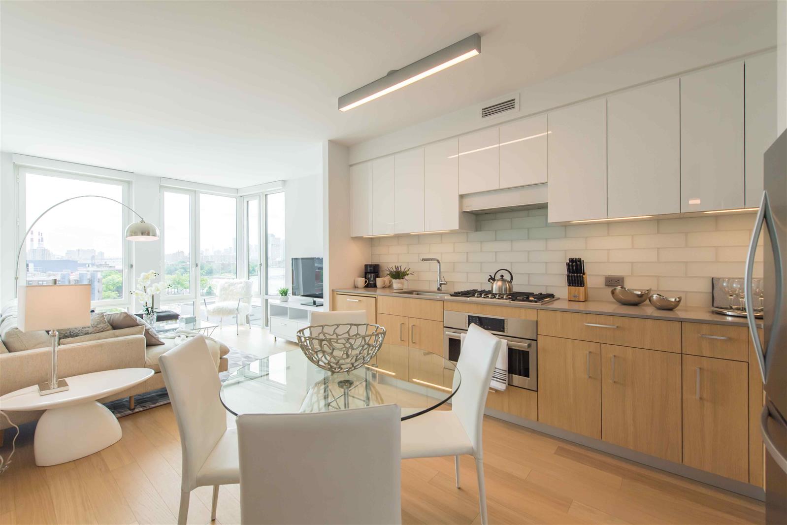 a view of a kitchen with kitchen island granite countertop a table and chairs