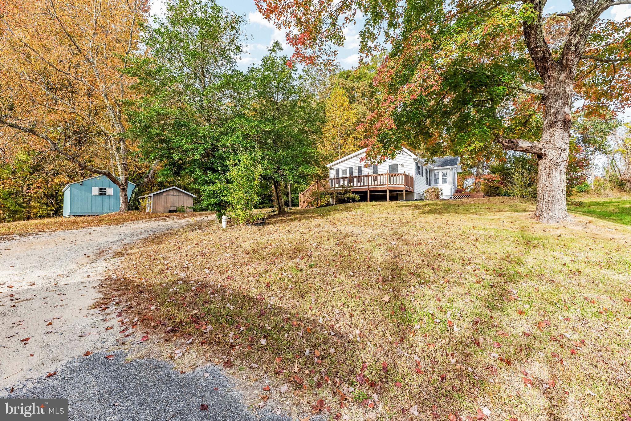 a yellow house with trees in front of it