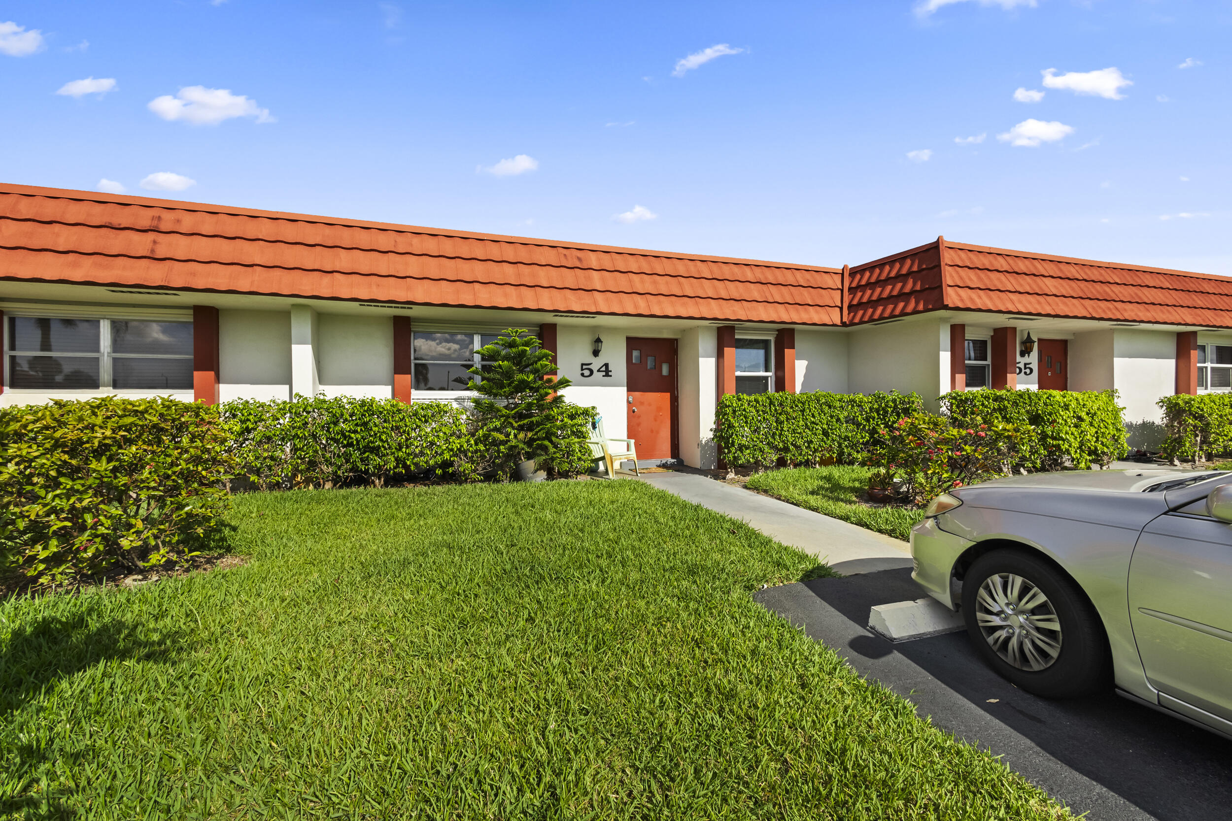 a front view of a house with a garden