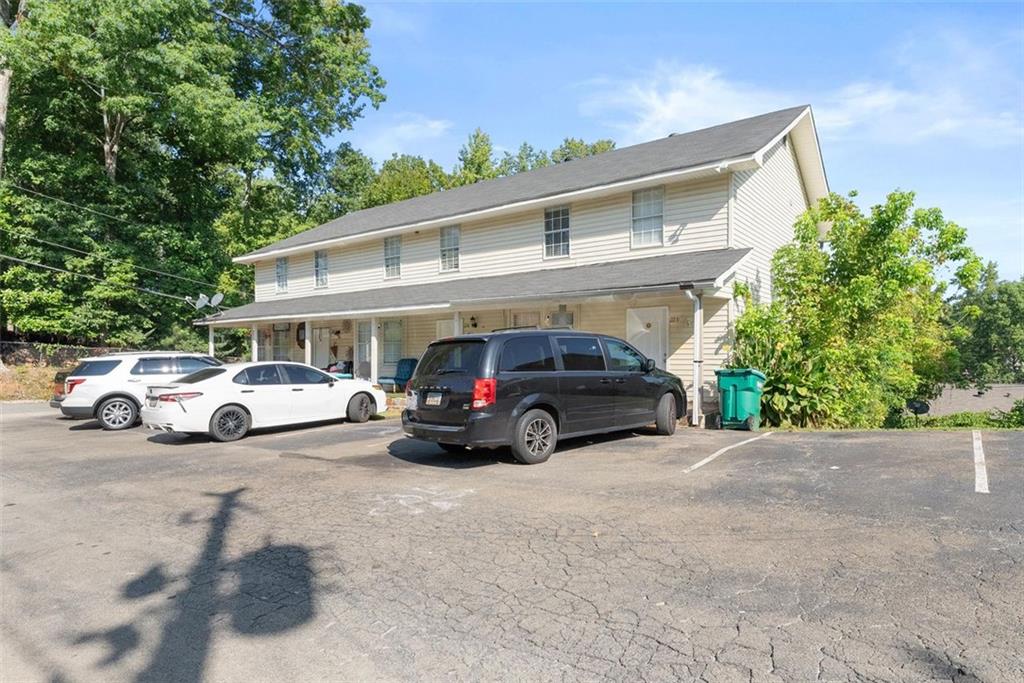 a view of cars parked in front of a house