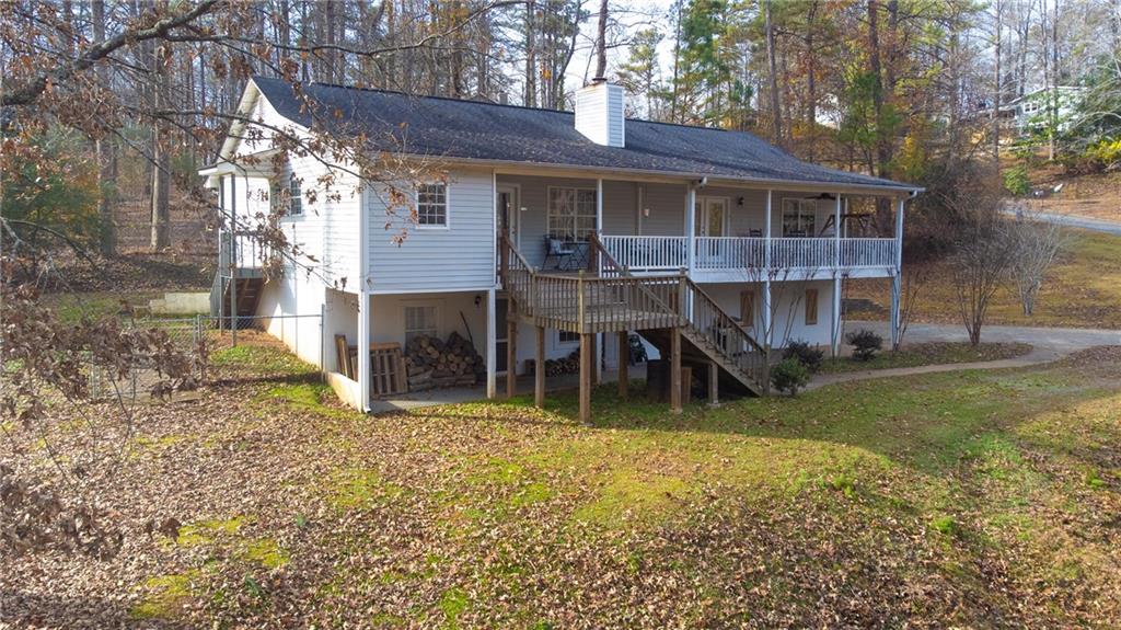 a view of a house with a yard and sitting area