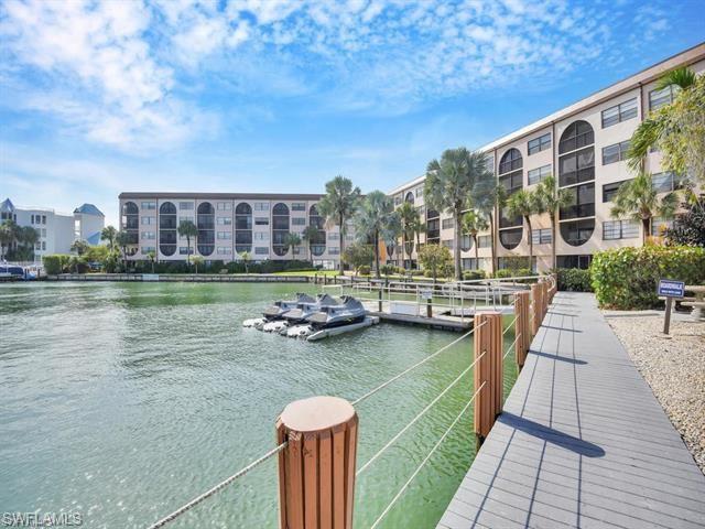 a view of residential houses with yard and lake view