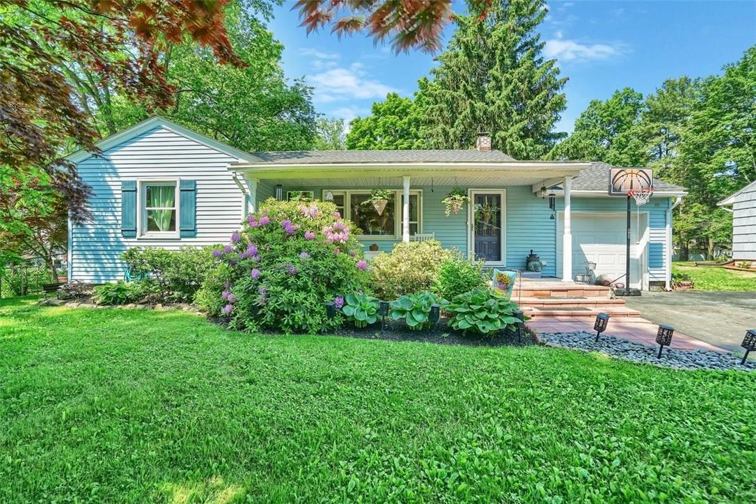 a front view of house with a garden