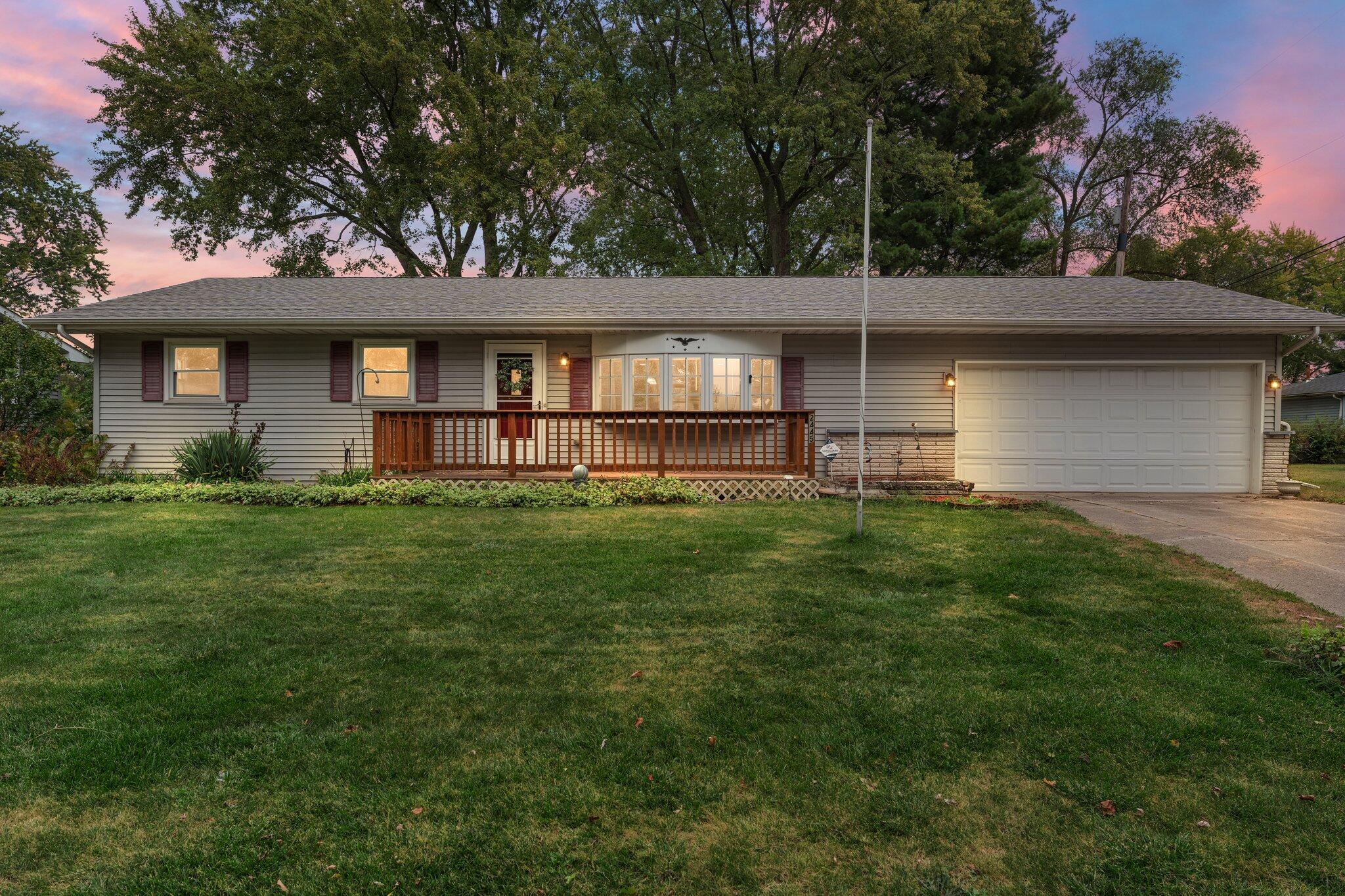 a front view of a house with a garden