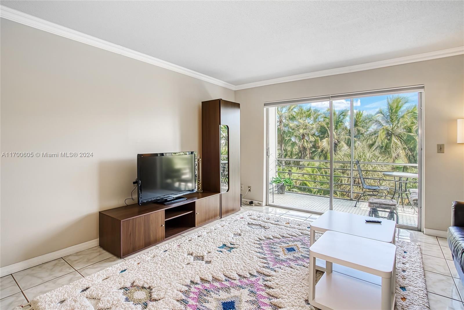 a living room with a flat screen tv and a floor to ceiling window