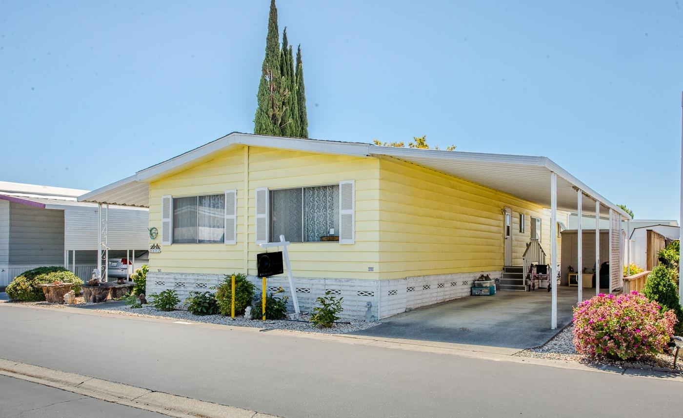 a front view of a house with a garden